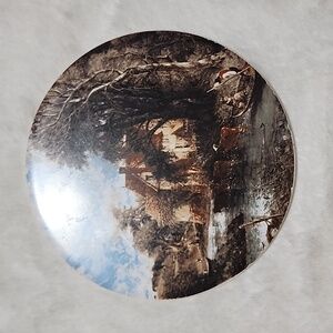 VINTAGE  CERAMIC  HOT PLATE WITH CORK PADDED ON THE BACK.